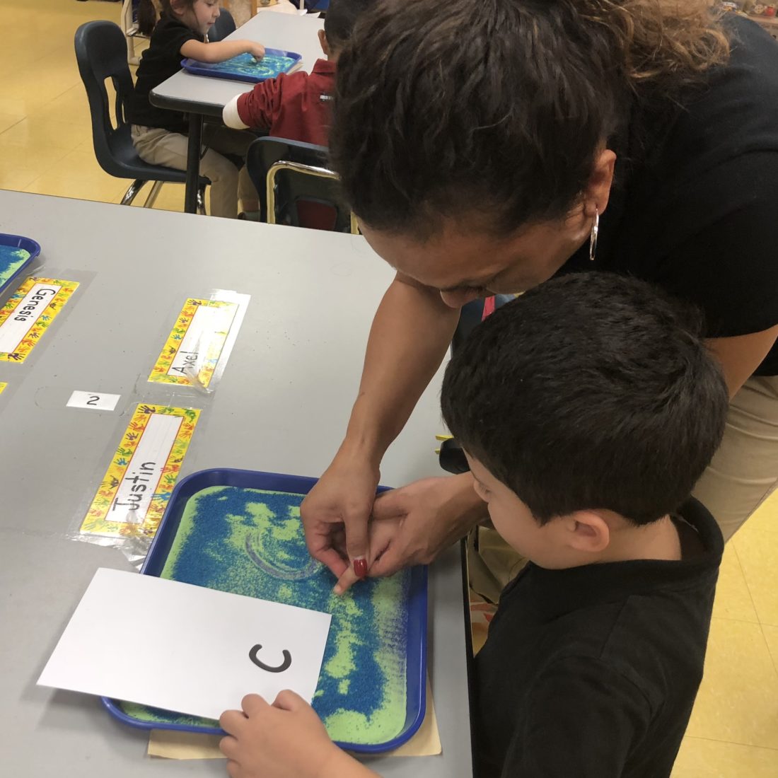 Teacher helping a student read