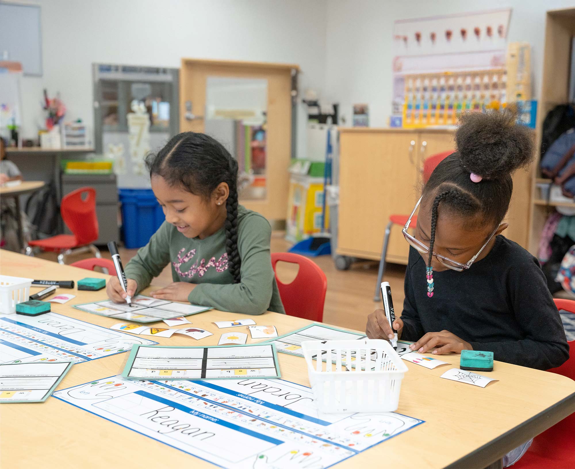 Two students completing learning activities